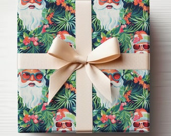 May include: A gift box wrapped in blue wrapping paper with a tropical print featuring Santa Claus wearing sunglasses. The paper has a repeating pattern of Santa Claus, tropical leaves, and flowers. The box is tied with a cream-colored ribbon.