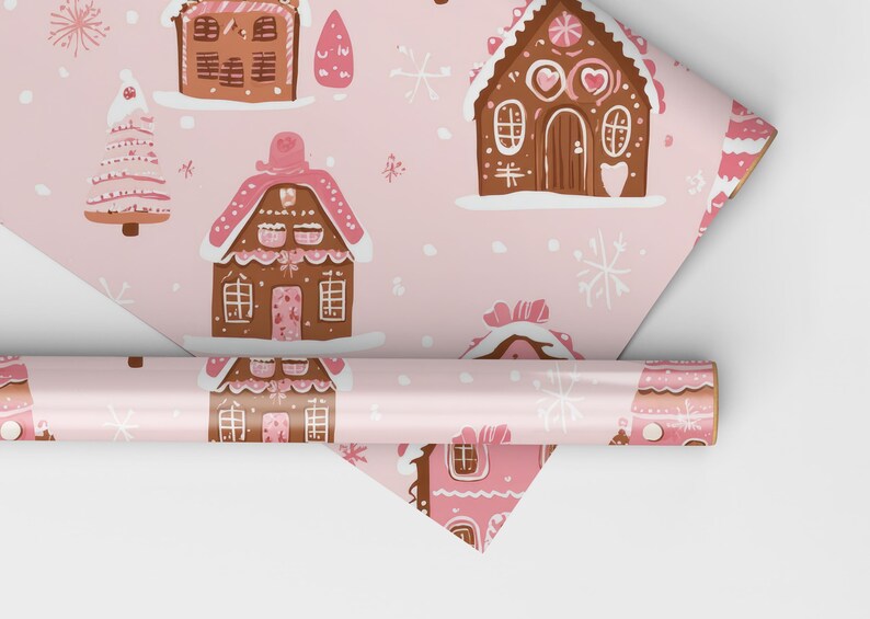 May include: Pink wrapping paper with a repeating pattern of gingerbread houses, candy canes, and snowflakes. The paper is rolled up and ready to be used.