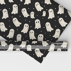 May include: Black and white wrapping paper with a repeating pattern of white ghosts. The ghosts are drawn in a simple, cartoon style.