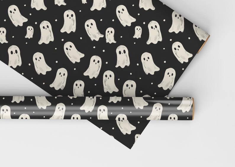 May include: Black and white wrapping paper with a repeating pattern of white ghosts. The ghosts are drawn in a simple, cartoon style.