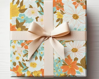 May include: A gift box wrapped in floral patterned paper with a light brown ribbon tied in a bow. The paper features a variety of flowers in shades of orange, yellow, blue, and white.