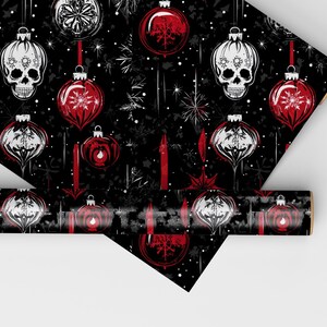 May include: Black and white wrapping paper with a repeating pattern of red and white Christmas baubles and skulls. The baubles have a snowflake design.