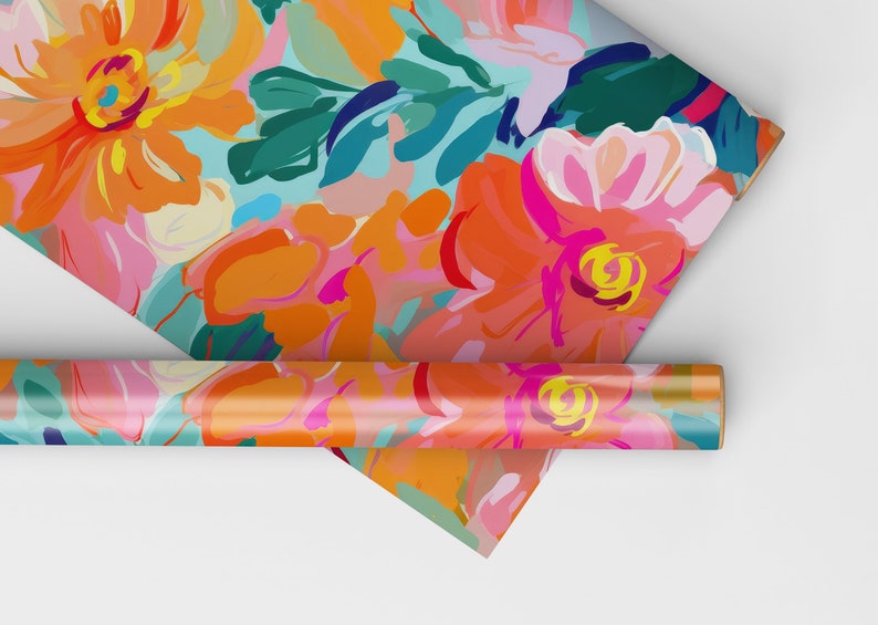 May include: A roll of colourful floral wrapping paper with a bright orange, pink and teal abstract floral pattern. The paper is rolled up and partially unrolled, revealing the pattern.