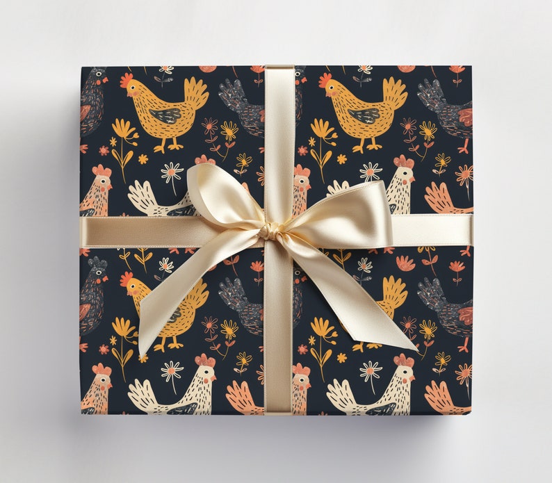 May include: A gift box wrapped in dark blue wrapping paper with a repeating pattern of yellow chickens and flowers. A gold ribbon is tied around the box with a bow.