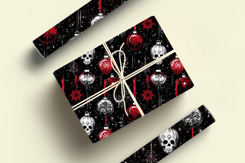 May include: Black and white skull Christmas baubles with red accents on a black background. The wrapping paper features a repeating pattern of the baubles and stars.