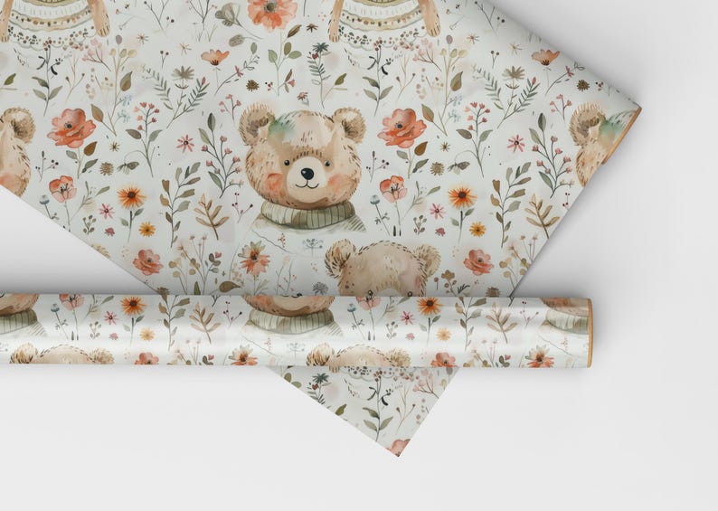 May include: White wrapping paper with a repeating pattern of brown teddy bears wearing sweaters, orange flowers, and green leaves.