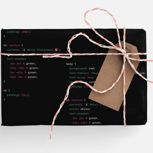 May include: A black gift box wrapped with white and pink twine and a brown gift tag. The box is decorated with code printed on the front. The code includes the text "A Merry Christmas".