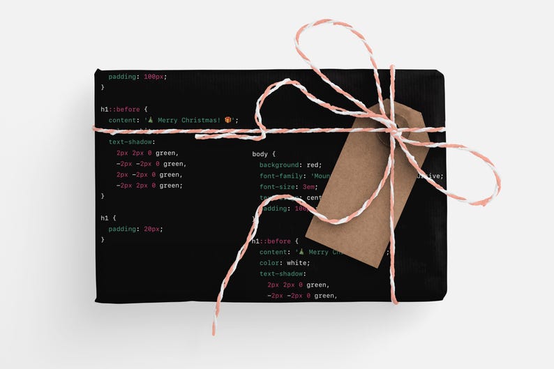 May include: A black gift box wrapped with white and pink twine and a brown gift tag. The box is decorated with code printed on the front. The code includes the text "A Merry Christmas".