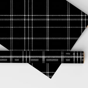 May include: Black and white plaid wrapping paper. The paper is rolled up and the end is visible.