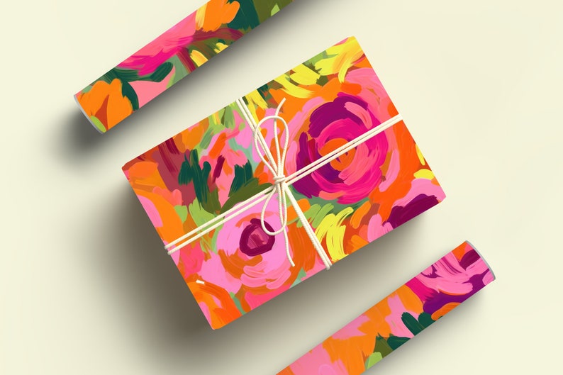 May include: A gift box wrapped in colorful floral patterned paper with a white ribbon. The paper features a bright pink, orange, yellow, and green abstract floral design.
