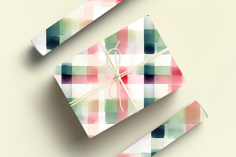May include: A gift wrapped in white paper with a watercolor plaid pattern in shades of pink, green, and blue. The gift is tied with a natural twine bow.