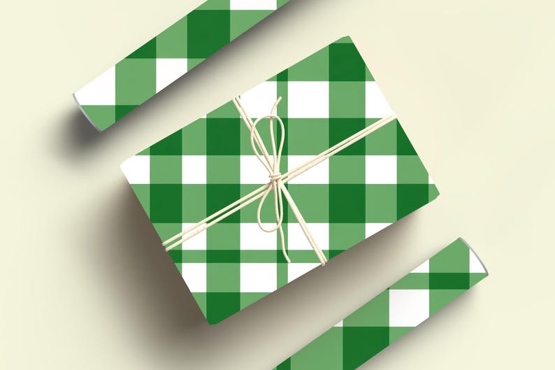 May include: A green and white gingham gift wrap with a white ribbon tied around it. Two rolls of the same wrapping paper are also shown.