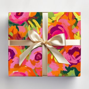 May include: A gift box wrapped in colorful floral patterned paper with a gold ribbon tied in a bow.