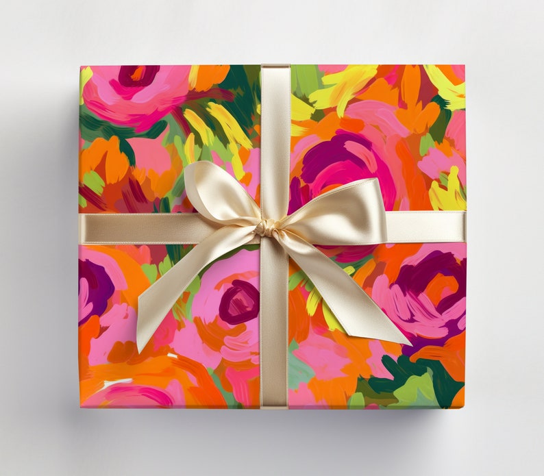 May include: A gift box wrapped in colorful floral patterned paper with a gold ribbon tied in a bow.
