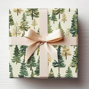 May include: A gift box wrapped in white wrapping paper with a green and gold watercolor pine tree pattern. The box is tied with a cream-colored satin ribbon.