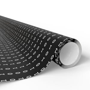 May include: A black and white patterned wrapping paper with a repeating pattern of the binary code "01" in white on a black background. The paper is rolled up and partially unrolled, showing the pattern.