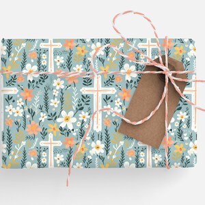 May include: A gift wrapped in blue floral wrapping paper with white crosses and a brown gift tag tied with twine.