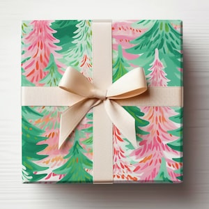 May include: A gift box wrapped in paper with a repeating pattern of stylized Christmas trees in pink, green, and orange. The box is tied with a cream ribbon and bow. The overall design is bright and cheerful, suitable for a holiday or celebratory occasion.