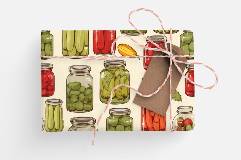 May include: A cream-colored gift wrap with a repeating pattern of jars filled with various pickled vegetables and fruits. The jars are drawn in a cartoon style and include red tomatoes, green cucumbers, green olives, and red peppers.