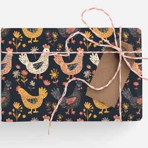 May include: A gift wrapped in dark blue wrapping paper with a pattern of colorful chickens and flowers. The gift is tied with white and pink twine and has a brown paper tag.
