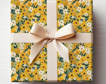 May include: A gift box wrapped in yellow floral patterned paper with a cream-colored satin ribbon tied in a bow.