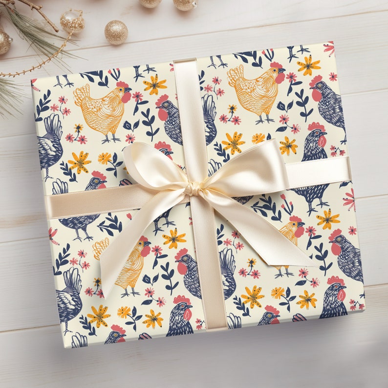 Puede incluir: Un papel de regalo de color crema con un patr&oacute;n repetitivo de pollos azules y amarillos y flores. Una cinta de color crema est&aacute; atada alrededor del papel de regalo con un lazo.