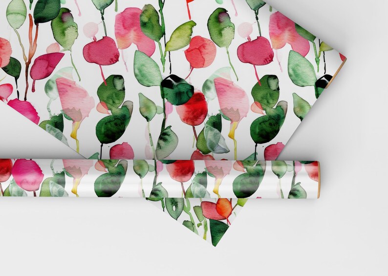 May include: A roll of white wrapping paper with a repeating pattern of pink and red watercolor flowers and green leaves.