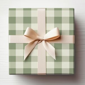 May include: A green and white gingham gift box with a beige satin ribbon tied in a bow.