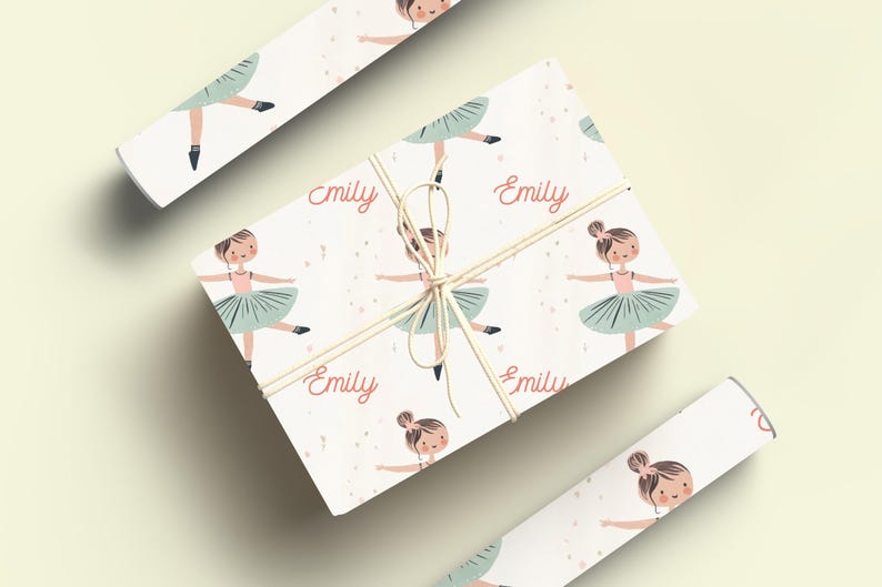 May include: White wrapping paper with a repeating pattern of a ballerina in a green tutu and the name "Emily" printed in pink.