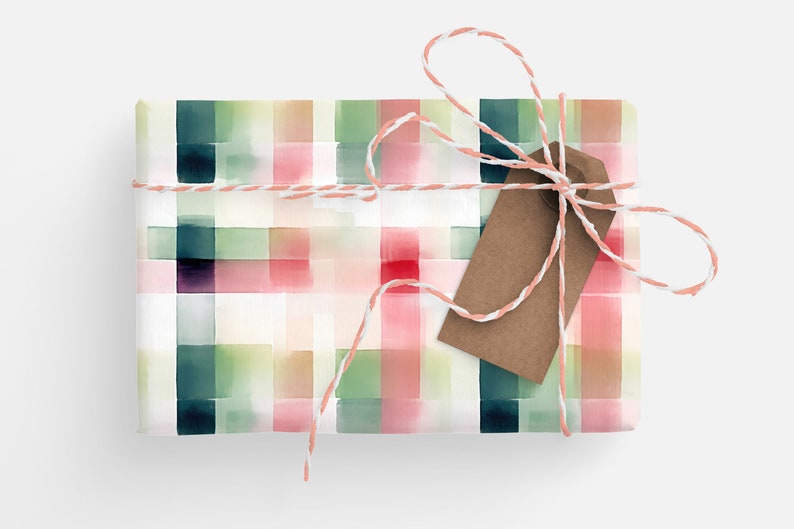 May include: A gift wrapped in white paper with a watercolor plaid pattern in shades of pink, green, and blue. The gift is tied with white twine and a brown gift tag.