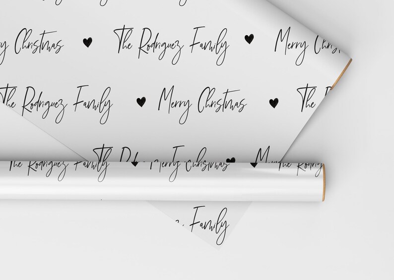 May include: White wrapping paper with a repeating pattern of black hearts, the text "Merry Christmas" and "The Rodriguez Family".