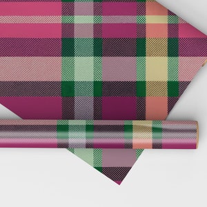 May include: A roll of pink, green, and yellow plaid wrapping paper. The paper is rolled up and the end is folded over.