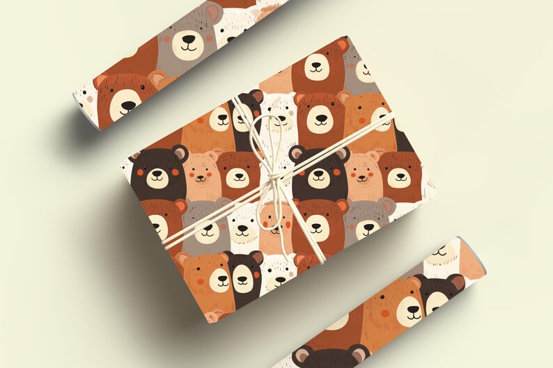 Op de afbeelding: Een bruin en wit cadeaupapier met een herhalend patroon van beren gezichten. De beren zijn in verschillende kleuren, waaronder bruin, wit en zwart. Het papier is vastgebonden met een wit touwtje.