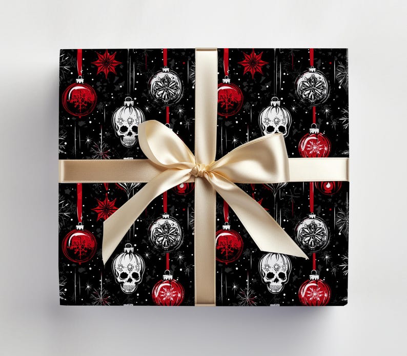 May include: Black and white wrapping paper with a repeating pattern of red and white baubles, stars, and skulls. The paper is tied with a gold ribbon.
