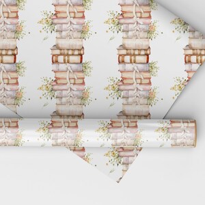 May include: White wrapping paper with a repeating pattern of stacks of vintage books tied with white ribbon and small bouquets of flowers.