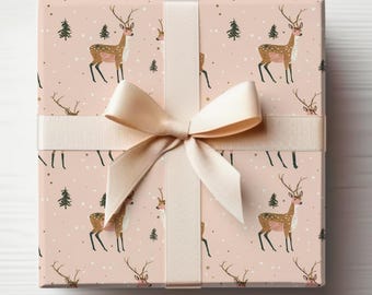Peut inclure: Un coffret cadeau emballé avec un fond rose clair orné d'un motif de cerfs, d'arbres et de flocons de neige. La boîte est nouée avec un ruban et un nœud de couleur crème, créant une présentation festive et saisonnière.