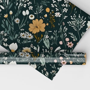 May include: A dark green wrapping paper with a floral pattern featuring white, yellow, and pink flowers. The paper is rolled up and ready to be used.