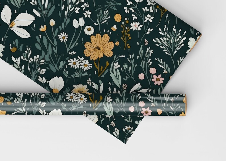May include: A dark green wrapping paper with a floral pattern featuring white, yellow, and pink flowers. The paper is rolled up and ready to be used.