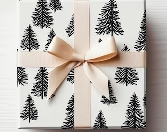 May include: A white gift box with a black and white pattern of stylized pine trees. The box is tied with a cream-colored ribbon.