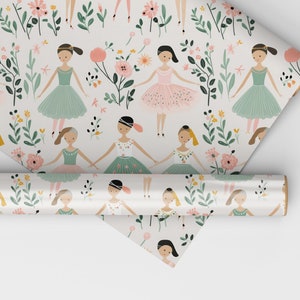 May include: A roll of white wrapping paper with a repeating pattern of ballerinas in pink and green tutus, flowers, and leaves.