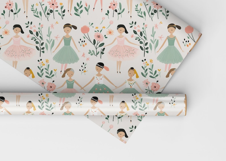 May include: A roll of white wrapping paper with a repeating pattern of ballerinas in pink and green tutus, flowers, and leaves.