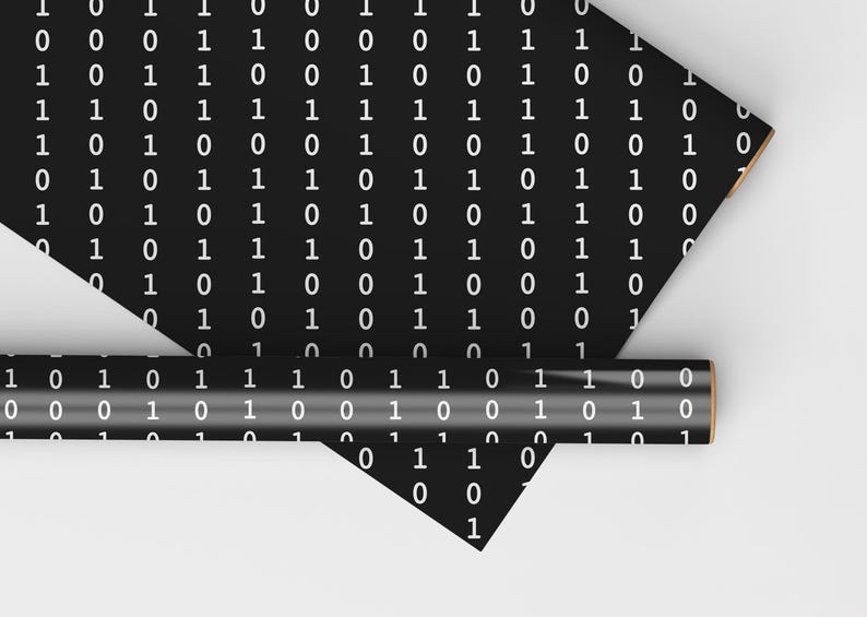 May include: Two rolls of black wrapping paper with a white binary code pattern. The paper is rolled up and the ends are visible.