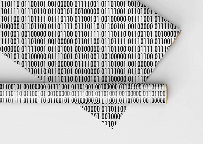 May include: White wrapping paper featuring a repeating pattern of black binary code. A partially unrolled roll and a folded sheet display the design. The paper has a light brown core.