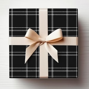 May include: A black and white plaid gift box with a beige satin ribbon and bow.