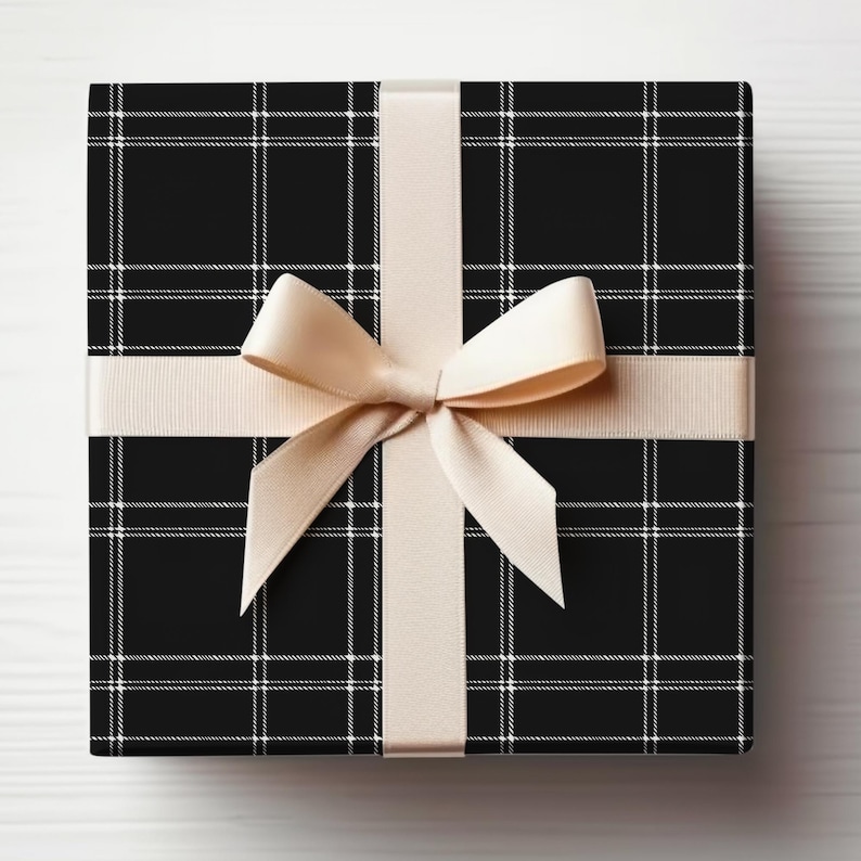 May include: A black and white plaid gift box with a beige satin ribbon and bow.