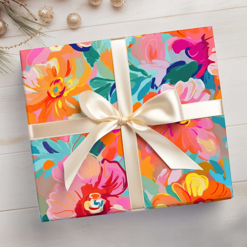 May include: A gift wrapped in colourful floral patterned wrapping paper with a cream-coloured satin ribbon tied in a bow.
