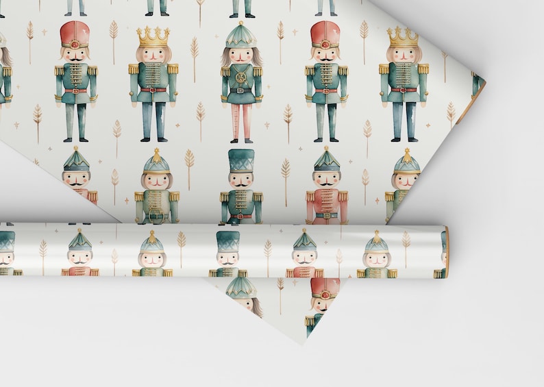 May include: White wrapping paper with a repeating pattern of watercolor nutcracker soldiers. The nutcrackers are wearing blue, red, and green uniforms with gold accents. The background is white with gold stars and small sprigs.