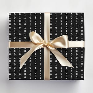 May include: A black gift box with a white binary code pattern and a gold ribbon tied in a bow.