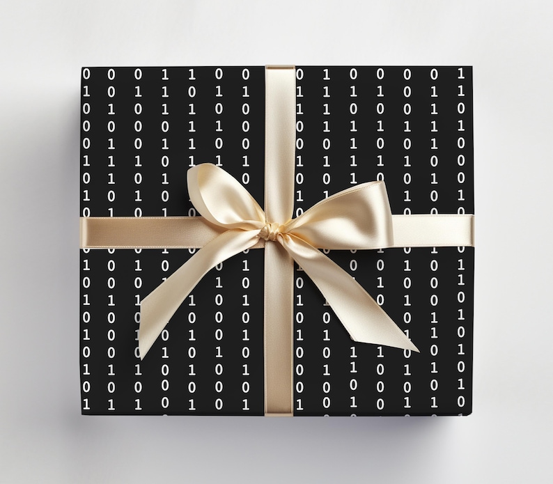 May include: A black gift box with a white binary code pattern and a gold ribbon tied in a bow.