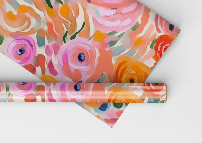 May include: A roll of wrapping paper with a floral pattern. The paper features pink, orange, and green flowers on a white background.